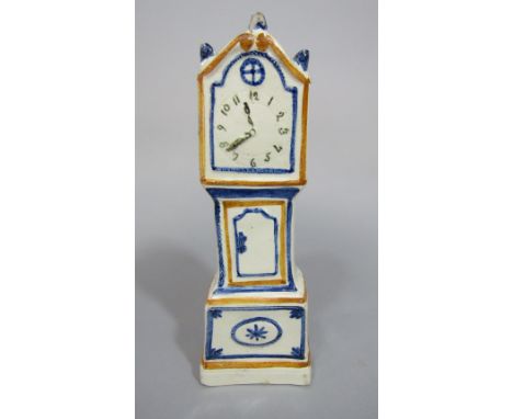 An early 19th century cream glazed model of a miniature longcase clock with painted detail in the Pratt palette, 21 cm tall, 