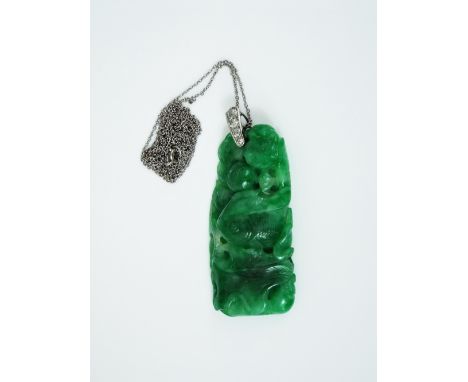 Early 20th century carved jade pendant depicting a fish and frog on a lily pad, the white metal bale set with four graduated 