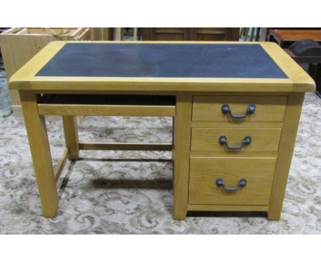 A good quality contemporary light oak kneehole desk, fitted with three long graduated drawers with heavy cast handles, flanki