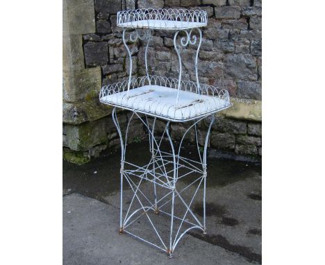 A wire work and light steel conservatory or garden plant stand on two graduated rectangular tiers, with hooped borders