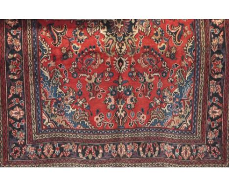 Full pile Persian Sarouk carpet, red ground, 300 x 220cm