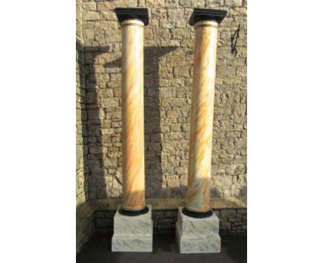 A pair of large architectural wooden cylindrical columns with all over later simulated marble hand painted finish and raised 