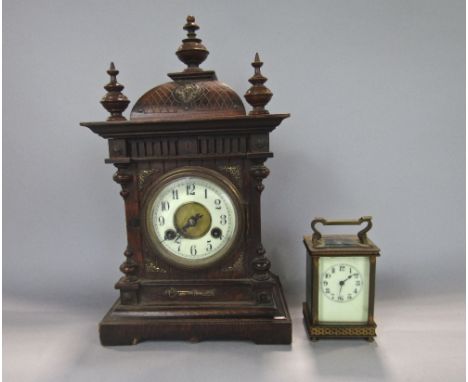 Continental twin train mantle clock with enamelled chapter ring and striking on a gong, 40 cm high, pendulum together with a 