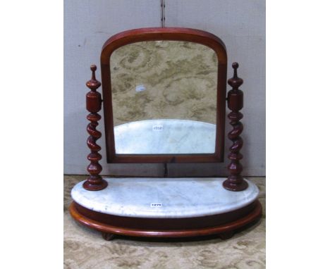 A Victorian mahogany toilet mirror of arched form, with spiral twist column supports and demi-lune platform base, with marble