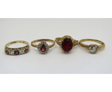 Four 9ct paste set dress rings to include a pink stone and cubic zirconia half hoop example, sizes K - Q, 8.9g total (4)