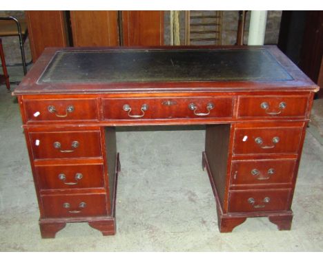 A reproduction Georgian style kneehole twin pedestal, mahogany veneered writing desk with green stained leather inset panelle