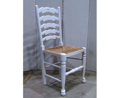 A set of four Lancashire style, wavy ladder back dining chairs with rush seats and later painted frames