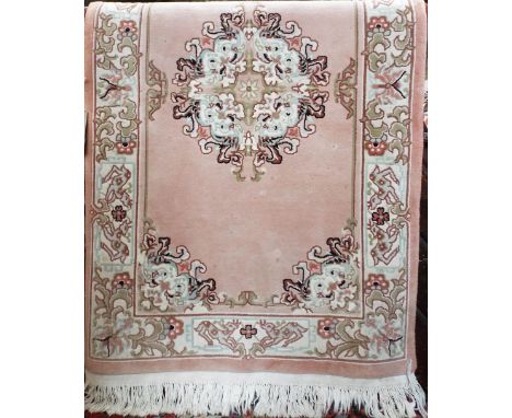 Eastern wool full pile rug/runner with central floral medallion upon a Salmon ground, 160 x 90cm