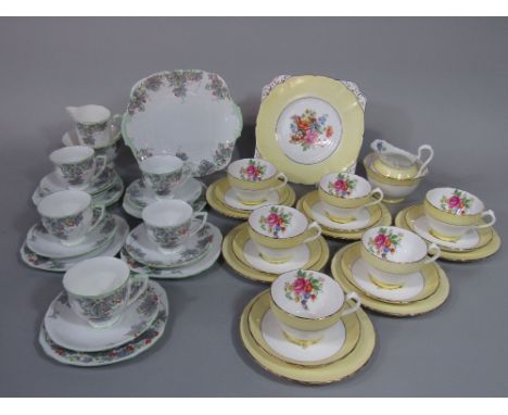 A collection of New Chelsea Staffordshire floral teawares with yellow border decoration, comprising milk jug, sugar bowl, cak