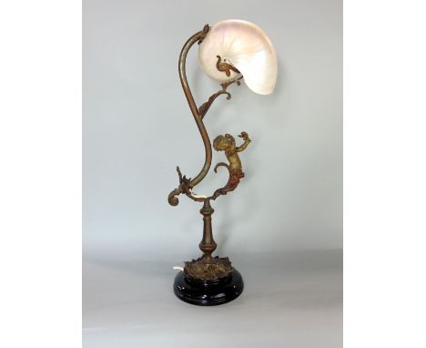 French cast metal figural table lamp decorated with a putti, with conche shell shade&nbsp;upon a stepped circular plinth base