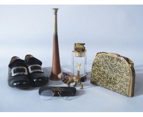 A box of interesting items to include a vintage vanity purse, a cast metal study of a lion, a pair of early Startrite shoes f