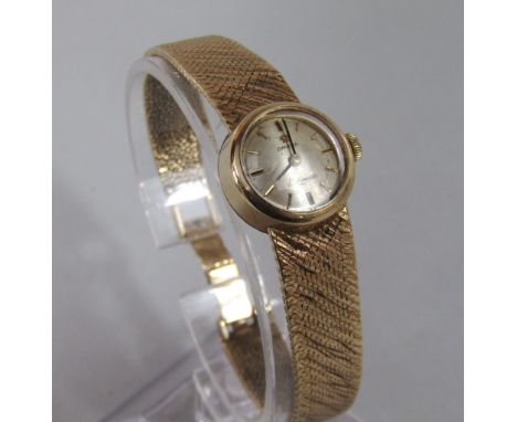 Vintage ladies 9ct Omega Lady Matic cocktail/dress watch, the champagne dial with gilt baton markers upon a mesh bracelet, 28