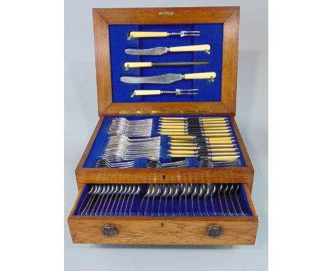 Good quality early 20th century golden oak cased canteen of cutlery, the hinged lid enclosing various knives, forks and teasp