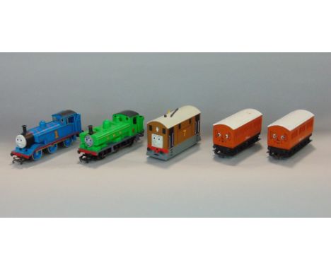 Five items from Hornby 00 gauge Thomas the Tank Engine series including Thomas, The Duck, Toby the Tram, Annie and Clarabel, 