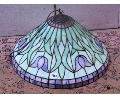A Tiffany style leaded light hanging ceiling light with domed shade and repeating foliate detail, 50 cm in diameter approx