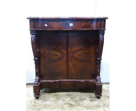 A Victorian mahogany side cupboard, the serpentine front fitted with a shallow frieze drawer, over a pair of well matched rec