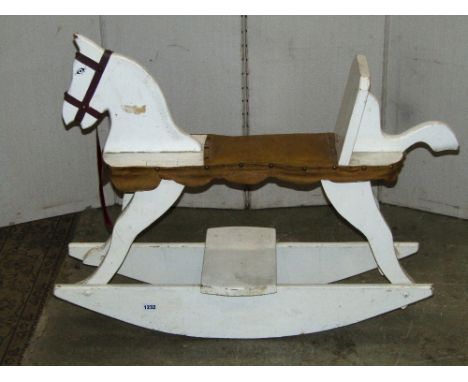 A rustic vintage child's wooden rocking horse with painted finish
