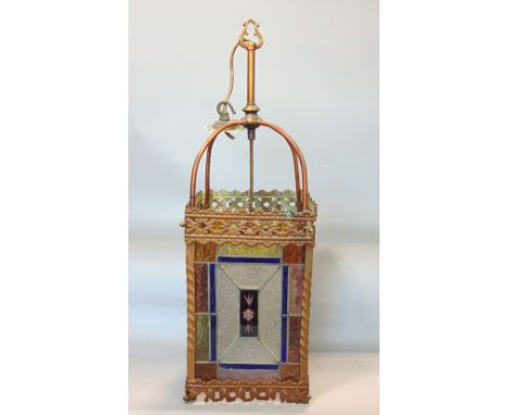 A Victorian brass framed hall lantern, with pierced borders and enclosing geometric leaded light panels with alternating colo