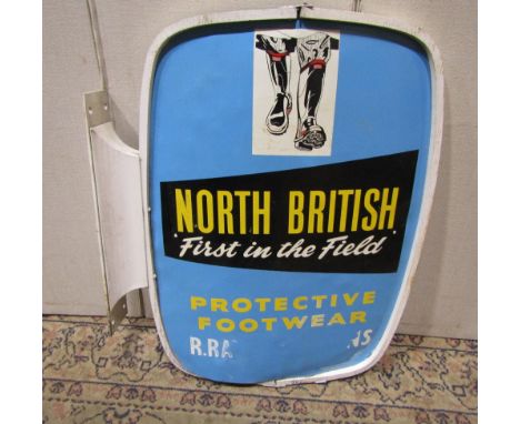 A vintage wall mounted metal sign advertising North British 'First in the Field' Protective Footwear