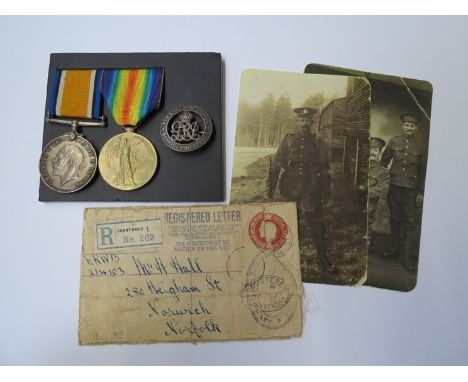 A WWI pair of medals together with Services Rendered wound badge to 32063 PTE. H. HALL NORF. R. with registered envelope for 
