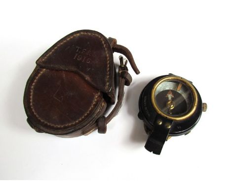 A WWI British marching compass with leather case, both dated 1916