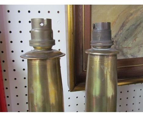 A pair of WWII brass shell cases converted into electrical table lamp bases, both dated 1943 