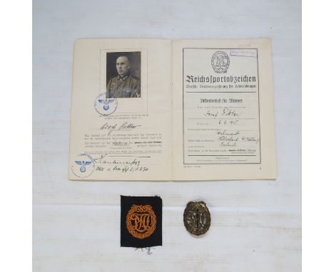 A WWII German issue DVL sports badge with cloth example and award document, together with a photograph of the serviceman in a