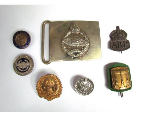 An RTC belt buckle with assorted badges including 1914 “On War Service”, New Zealand Women's Land Army, Bradford Home Guard, 