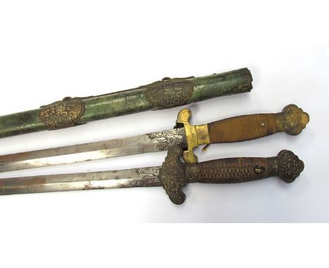 A late 18th Century Chinese Quianglong Dynasty Shuang Jian double sword, the woven cloth grips with chased and engraved gilt 