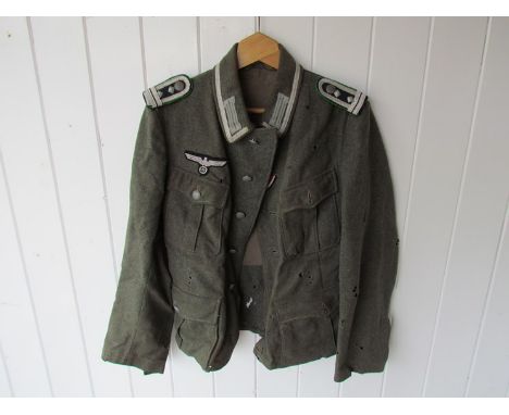 A WWII German M36 Army Tunic with correct insignia mothed