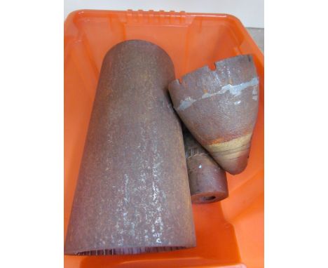 A section of rifled gun barrel with solid shot artillery shell head and top section of WWI timer shell head