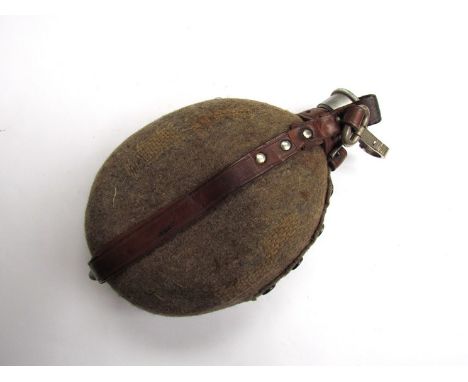 A Third Reich era German Army water bottle with brown leather strap, old repairs