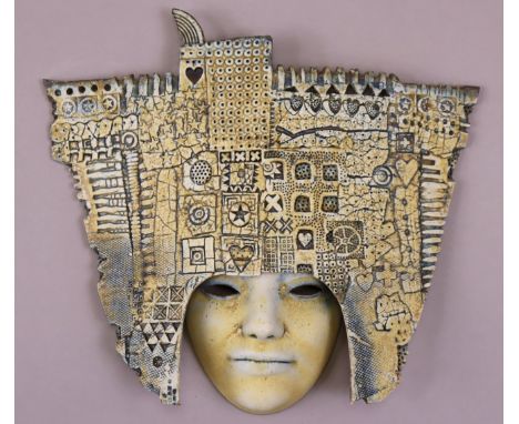 ALASDAIR NEIL MACDONELL (b. 1947) a ceramic wall mask with blue glaze, impressed initials “ANM BATH” to reverse, 28cm high x 