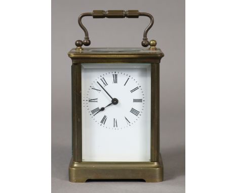 A brass carriage timepiece with black roman numerals to the white enamel dial; 10cm high.