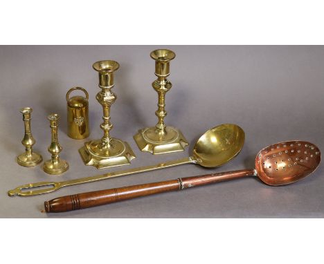 A pair of 19th century brass candlesticks on square bases with re-entrant corners, 18cm; a pair of miniature brass candlestic