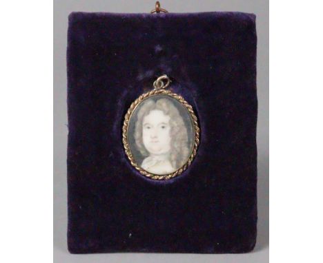ENGLISH SCHOOL, 18th century. A portrait miniature of a gentleman, with long curled hair, 4.3cm x 3.7cm (oval, on ivory), mou