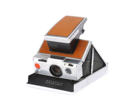 A Polaroid SX-70 Land Instant Folding SLR Camera 1972-77, light tan, body G, lens F-G, loaded with part-used expired film