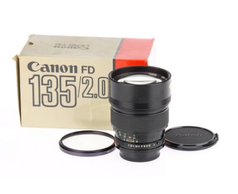 A Canon FDn f/2 135mm Lens date code 1983, serial no.19368, body VG, optics F, edge fungus to rear element, with caps, retail