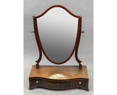 A George III mahogany boxwood strung tulipwood crossbanded shield shape swing toilet mirror, the serpentine fronted box plate