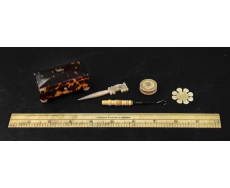 An early 19th century tortoiseshell veneered needle packet box, with domed hinged cover, on turned bone feet, 6.5cm wide, a b