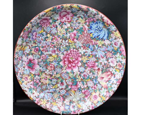 Chinese porcelain hand enameled plate decorated with a central chrysanthemum and other flowers. Having makers character marks