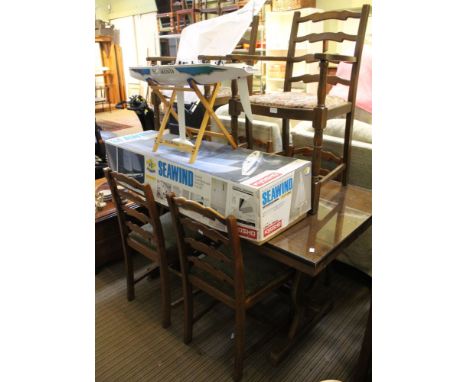 An oak refectory table on trestle frame with a set of six ladder back dining chairs, two carvers
