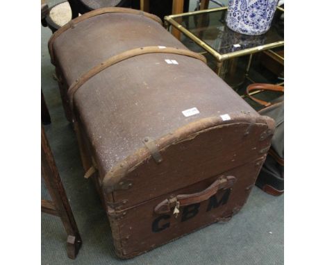 A vintage domed top wooden bound travel trunk