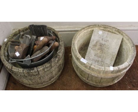 Two cast garden planters with a bucket of vintage tools