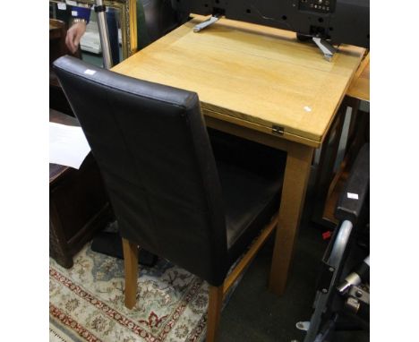 A modern light oak twin flap flip top table with two leather effect chairs