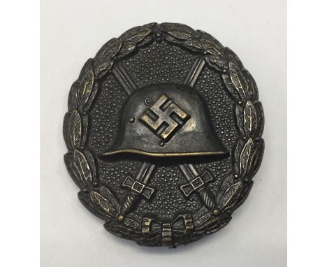 A scarce black grade German wound badge in the so called ‘Condor Legion’ pattern, from circa 1939. The badge is transitional 