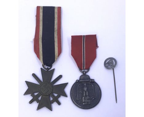 A trio of WW2 era German items To included: the Eastern Front Medal, or Russian Front Medal, the War Merit Cross with Swords,