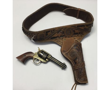Decorated inert model Colt Western era single-action-action .45 revolver by Denix, Spain. Black and gold finish with moving c