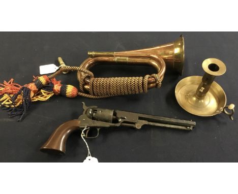 A decorative brass and copper bugle, with rope tassels, a modern brass chamber stick, and a replica Navy Colt percussion revo