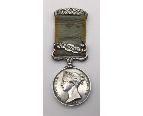 A Crimea Medal, with clasp for Sebastopol, named to W.Gridley of the 10th Hussars. Fitted with a contemporary silver laurel l
